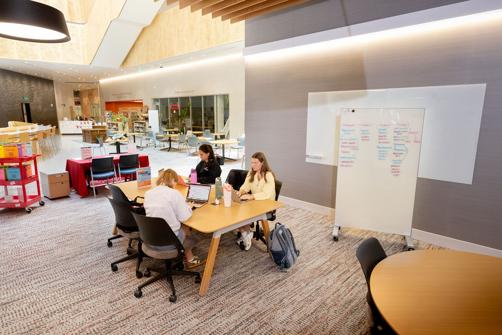 Small group of students works on academic assignments in a tutoring center.